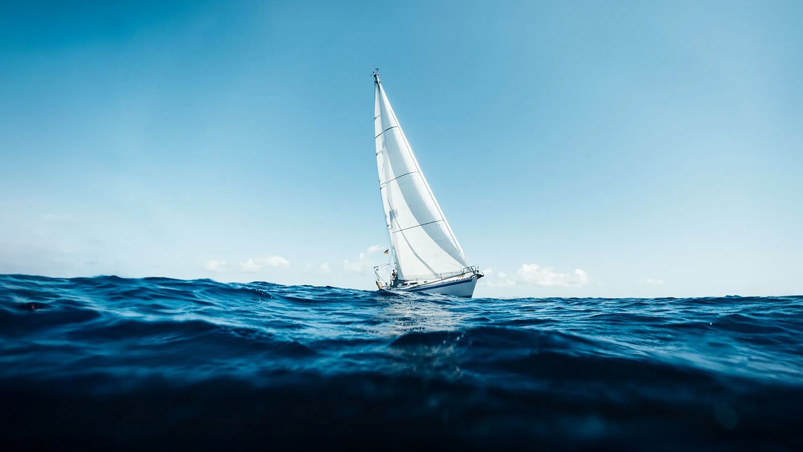 A sailboat on open water, reflecting Modon's coastal vision